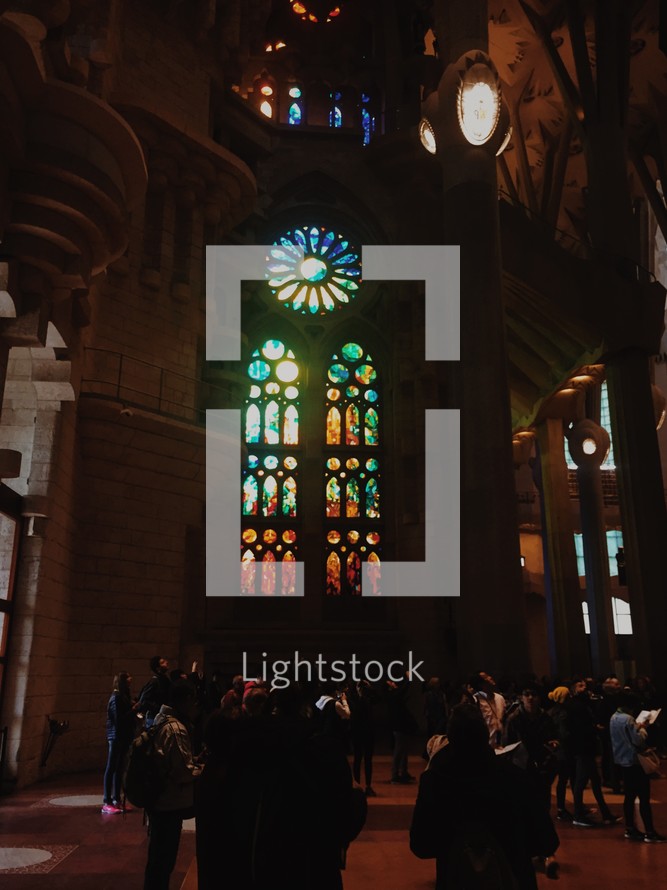 tourists viewing stained glass windows 