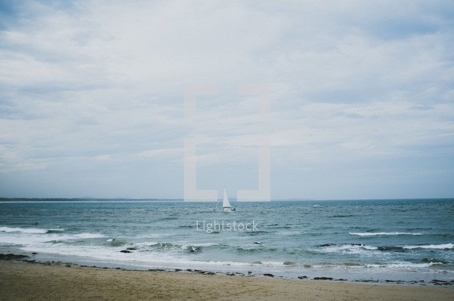 sailboat on the ocean from the beach 