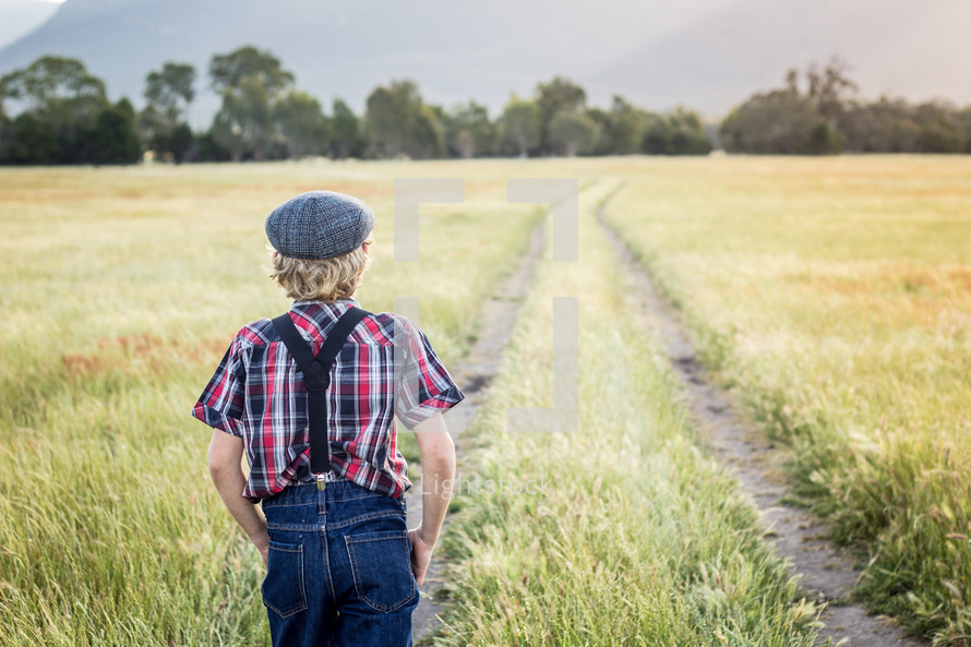 a boy walking in a field 