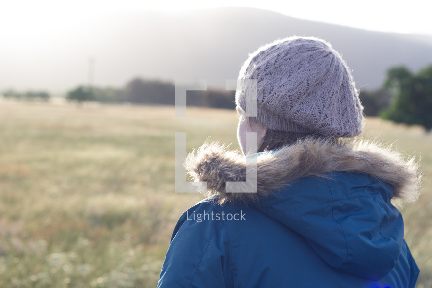 a woman standing outdoors in winter 