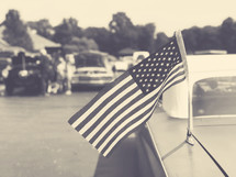 Vintage american flag on an old classic car antenna