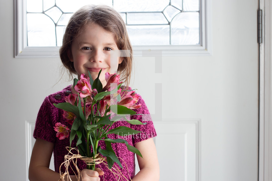 child holding Alstroemeria flowers 