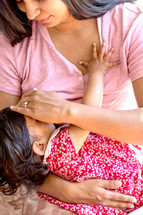 Mother nursing daughter 