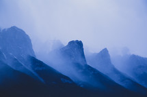 mountain peaks in dense fog 
