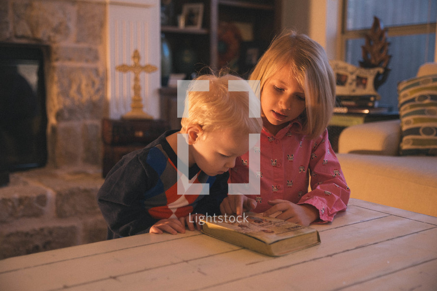 children reading a Bible together 