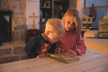 children reading a Bible together 