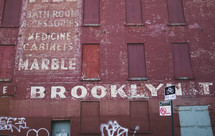 word Brooklyn painted on a brick wall 