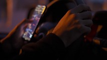 A man looking map on his mobile phone during driving at night.