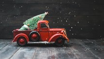 red truck with a Christmas tree 
