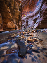 rocky river bed and red rock cliffs
