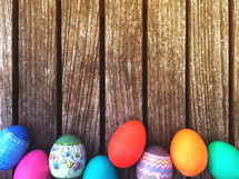 Easter eggs border on wood background