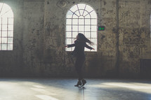 woman dancing in an empty warehouse 