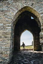 child running through an old castle 