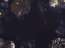 border of fireworks bursting in the night sky 