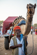 a man leading a camel 