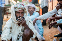 men smoking cigarettes in India 