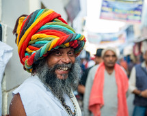 a smiling man with a colorful turban in India 