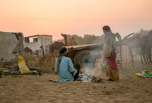 men sitting by a fire in India 