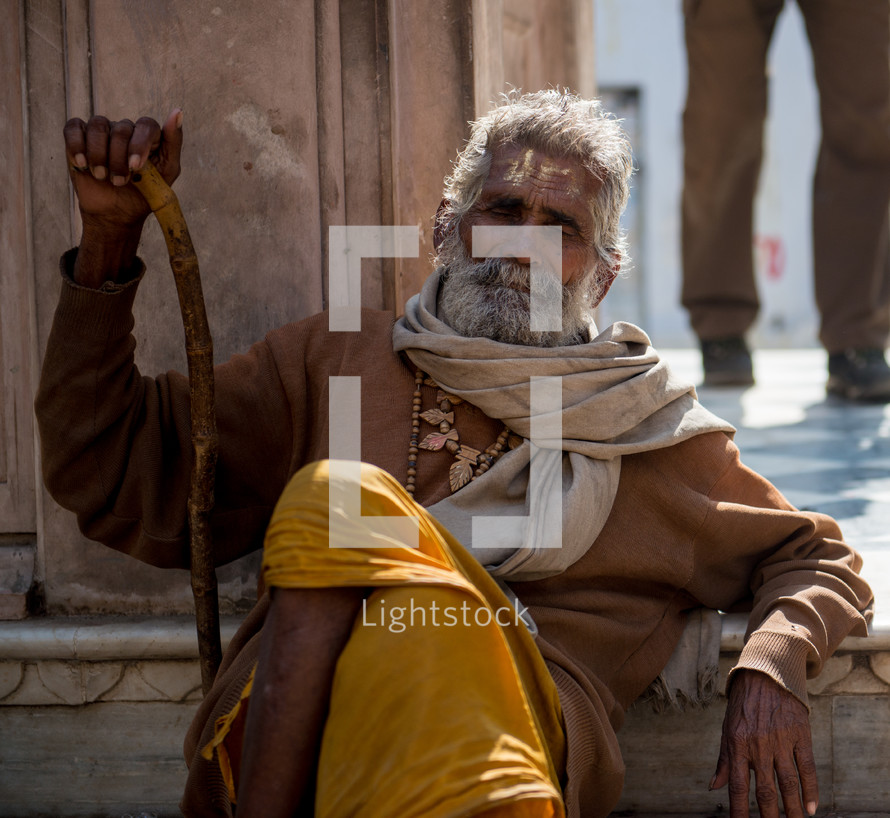 a man with a cane in India 