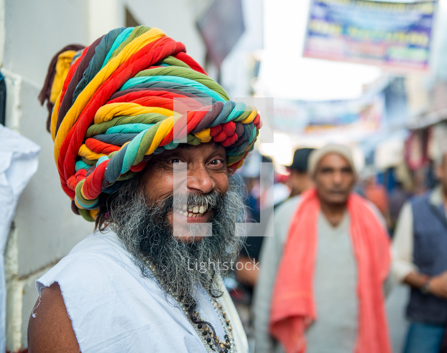 a smiling man with a colorful turban in India 