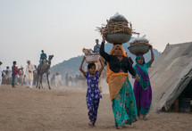women carrying items on their heads in India 