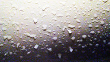 water droplets and condensation built up on a glass surface. 