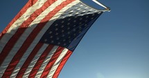 American, USA flag blowing in the wind in slow motion on 4th of July, United States Independence Day.