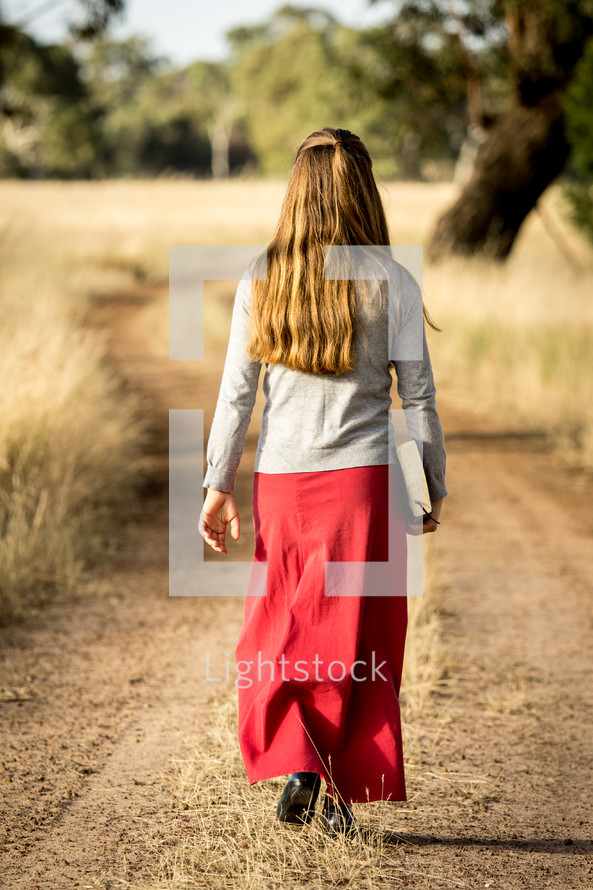 Lady going for a walk with Bible 