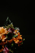 Colorful flower arrangement on black background.