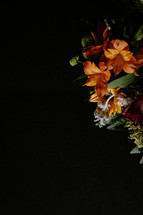 Colorful flower arrangement on black background.