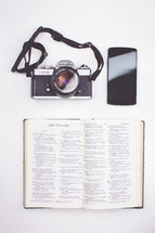 camera, cellphone, and open Bible 