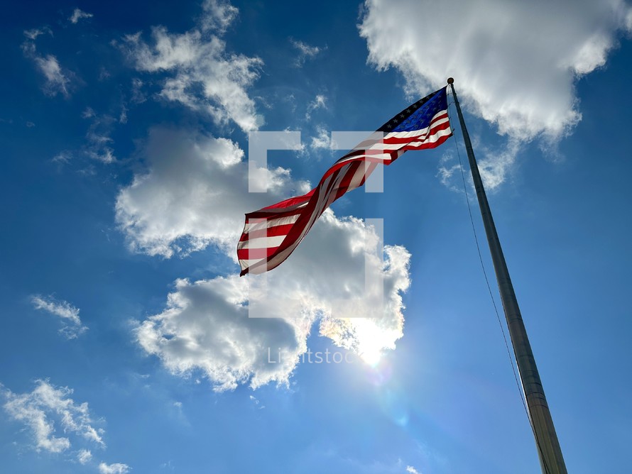 American flag waving against blue sky