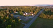Aerial view over a rural church in fall 