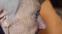 Close up side view of an elderly person.