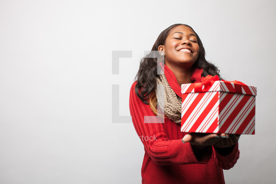 A woman holding a Christmas present. 