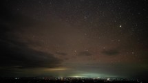 4K Milky Way Beautiful Cloudy Starry Night Sky Astro Galaxy Universe  and The City Time Lapse