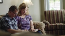 husband and wife reading a Bible together 