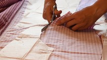 seamstress cutting fabric 