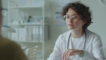 Female Physician Having Conversation with Patient in Clinic
