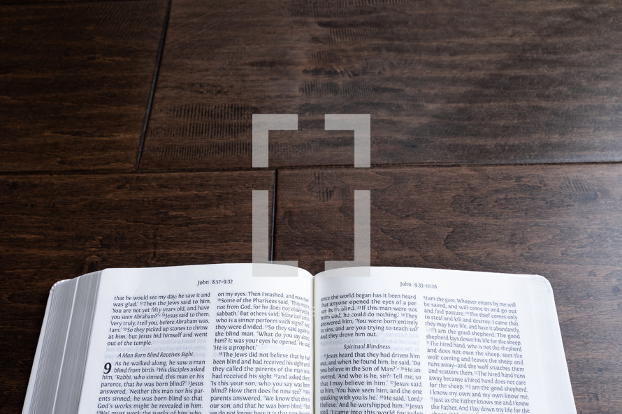 open Bible on a wood background  
