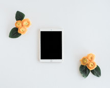 yellow roses and tablet 