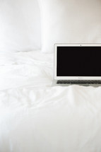 laptop computer on a bed 