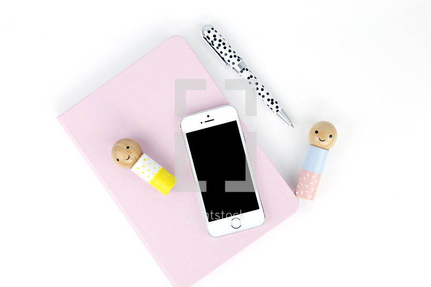 iPhone, wooden people, pen, notebook, desk, white background 
