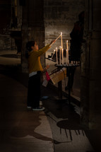 children lighting candles at church 