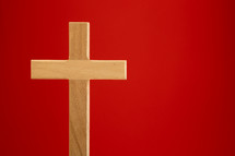 Wood cross on a red background