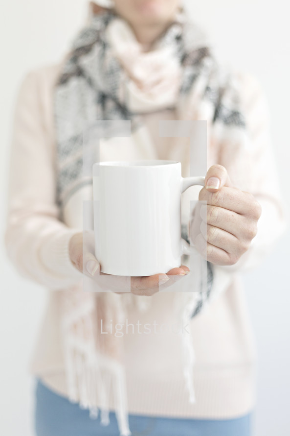 a woman holding a coffee mug 