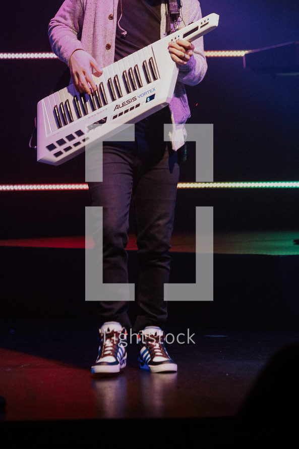 Man playing keytar on a stage