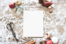 white paper and festive items in snow 