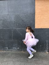 child in a tutu dancing 