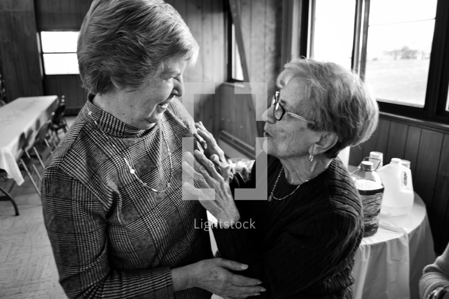 elderly women hugging in friendship 